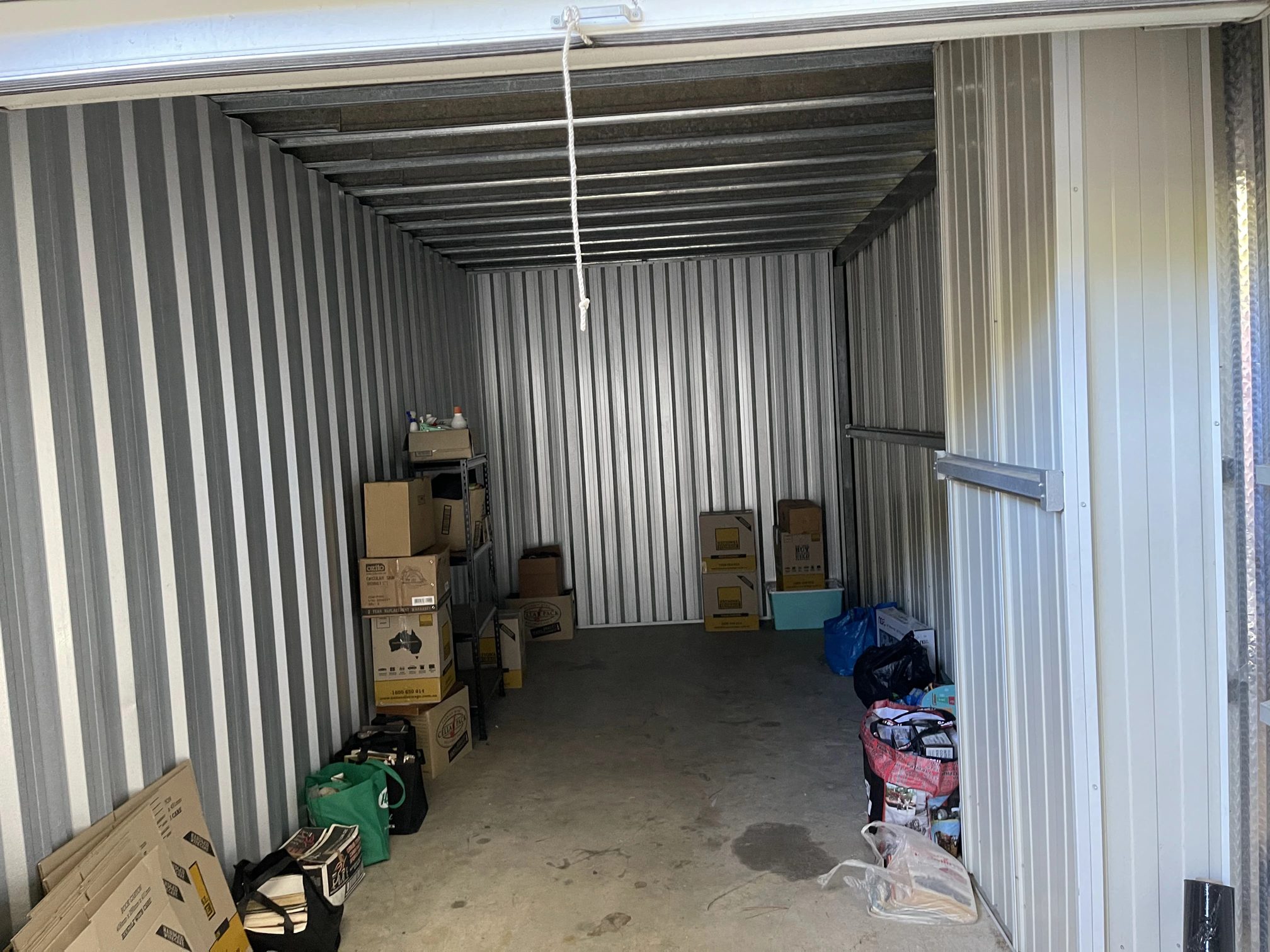 Storage unit with boxes and furniture stored on shelving