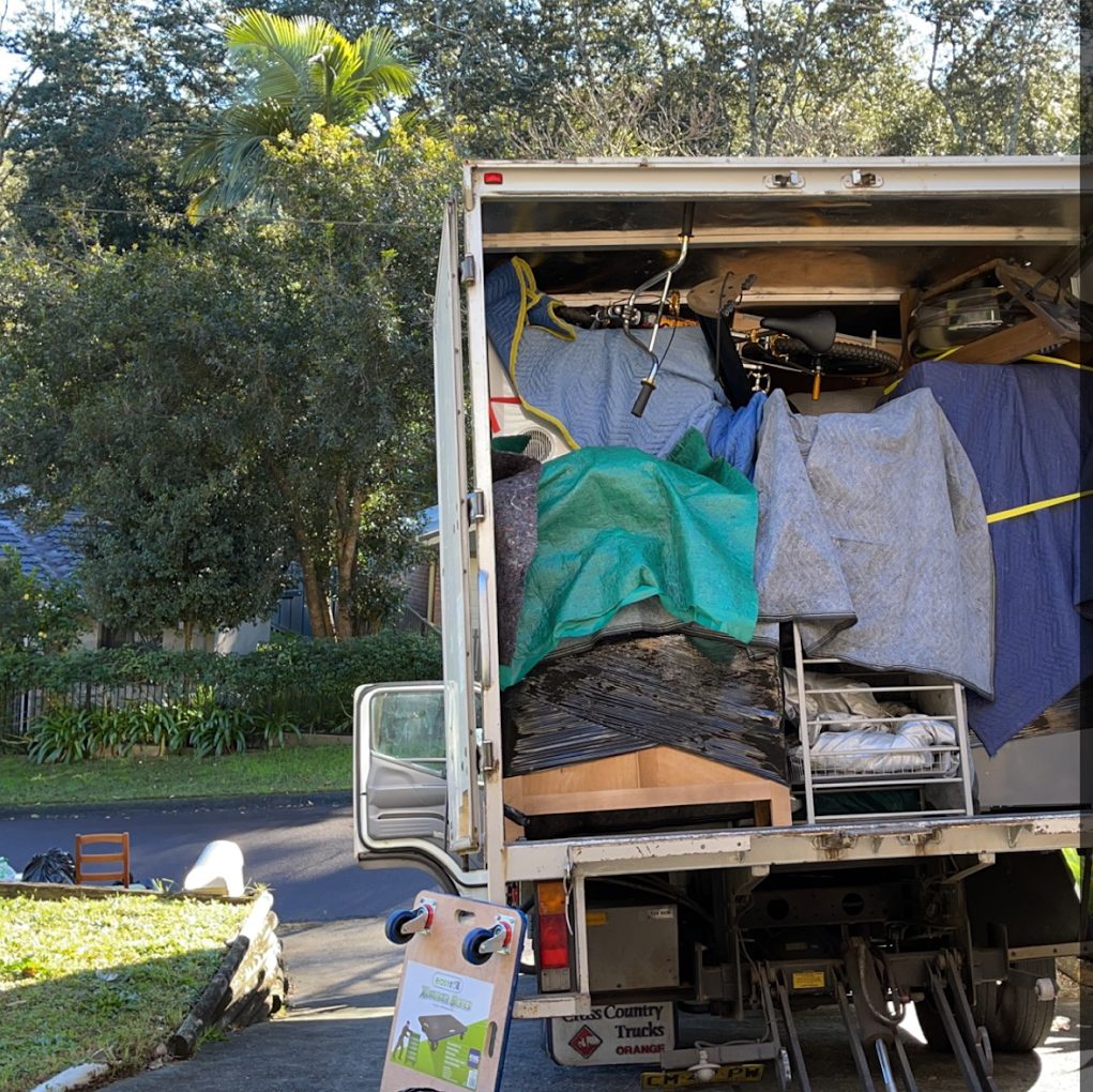 Truck loaded with furniture wrapped in moving blankets